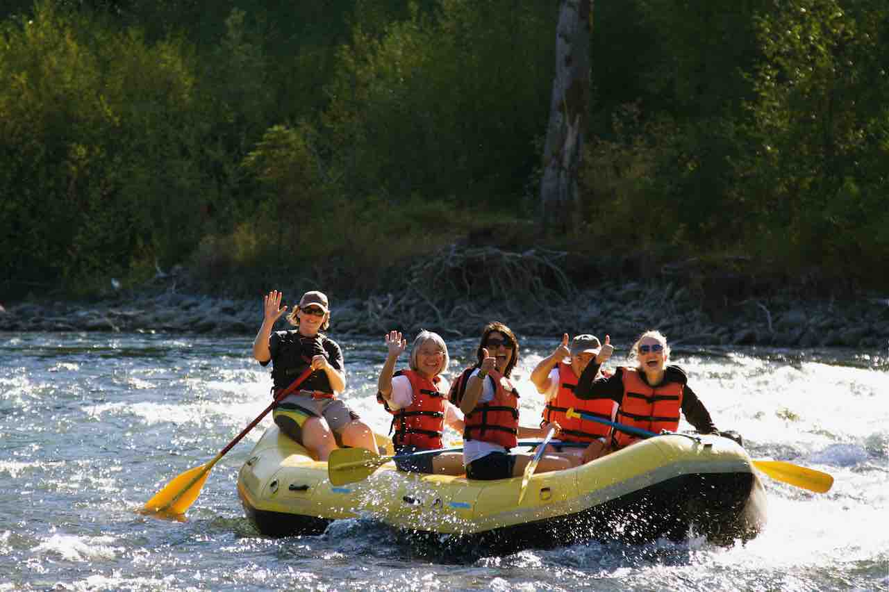 Family and guide having fun rafting on the Elwha River in Olympic National Park